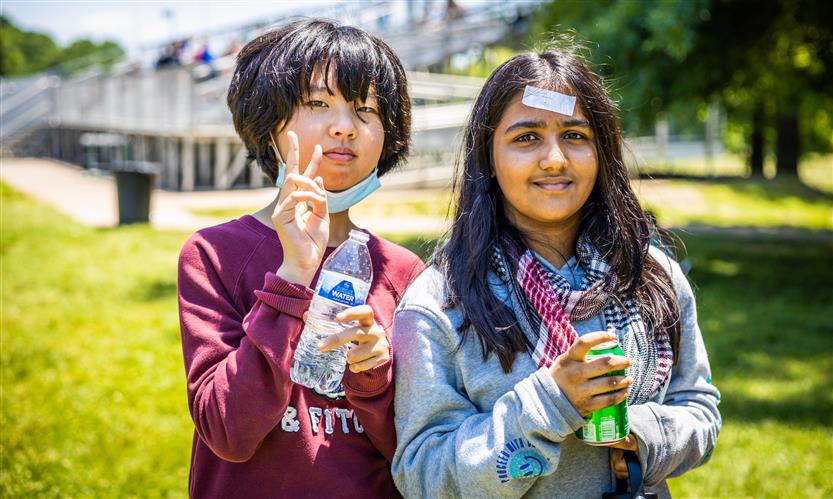 Two girls smile while outside